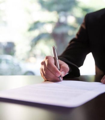 Businessman Signing Contract or Legal Papers